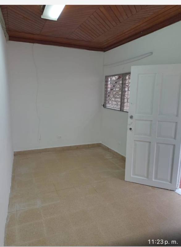 Empty room with white walls, wood ceiling and tiled floor in San Antonio rental property