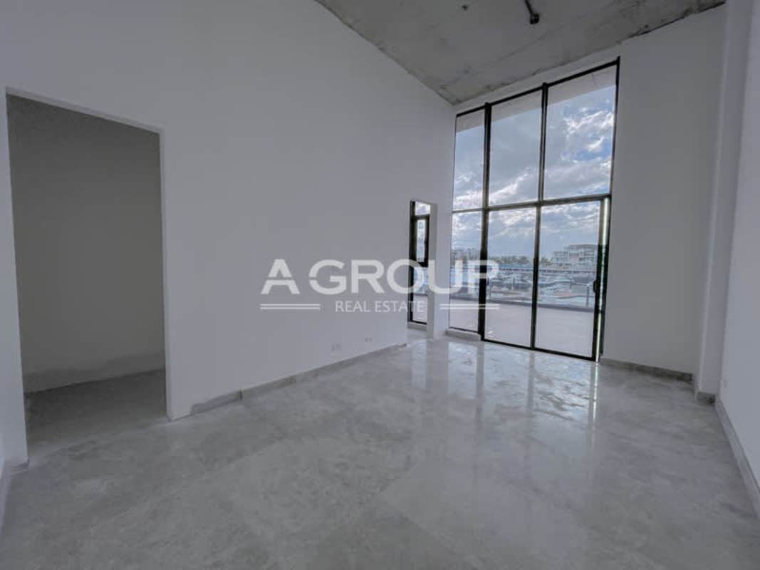 Modern luxury penthouse double height living room with marina view at Montecarlo Tower Ocean Reef