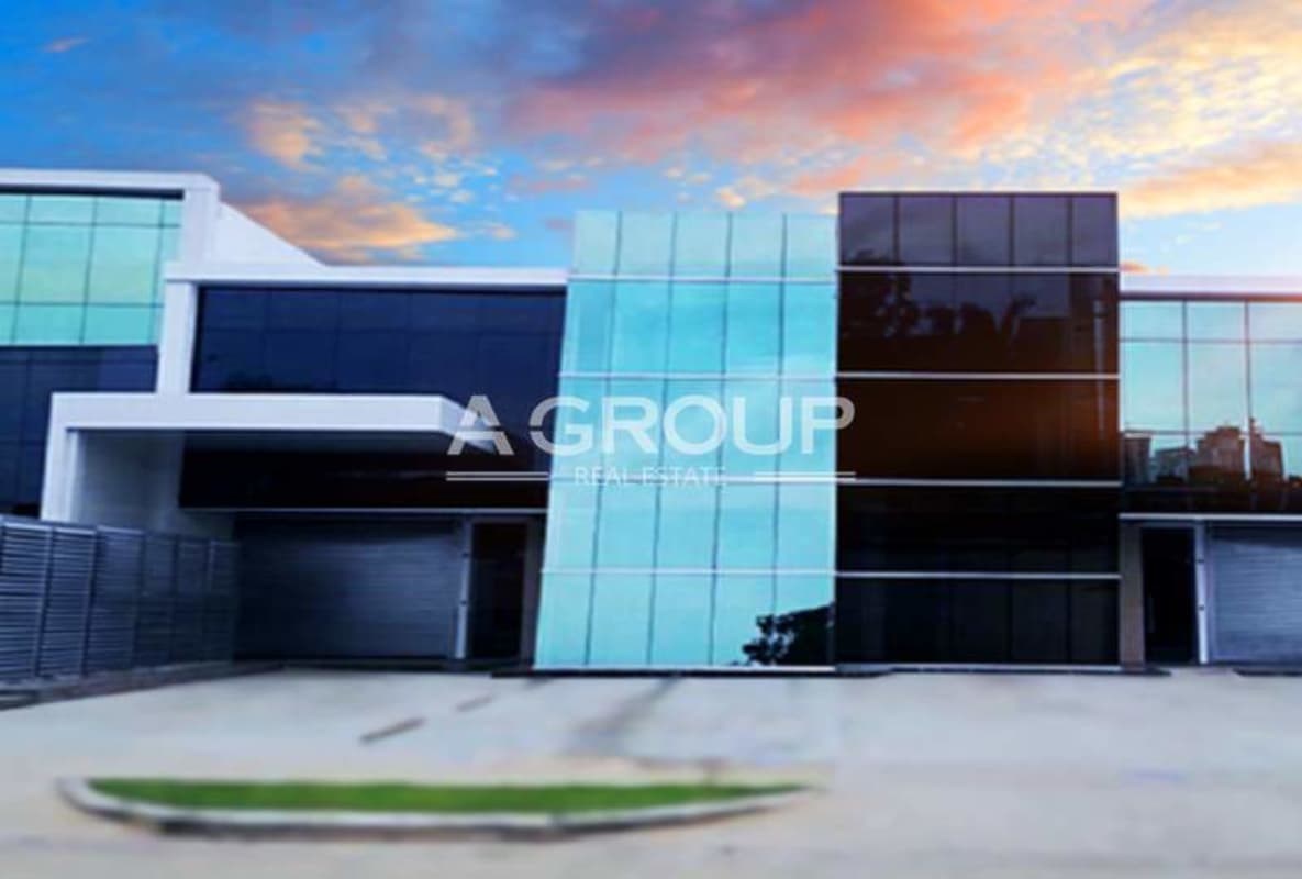 Exterior of modern commercial unit with blue glass panels at Panama Viejo