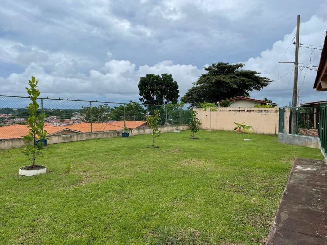 Modern kitchen with stainless steel counters, wooden cabinets, large window Brisas del Golf Panama