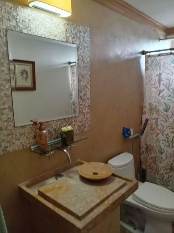 Luxury bathroom with vessel sink stone counter mosaic tile wall PH Las Palmeras Bella Vista Panama City