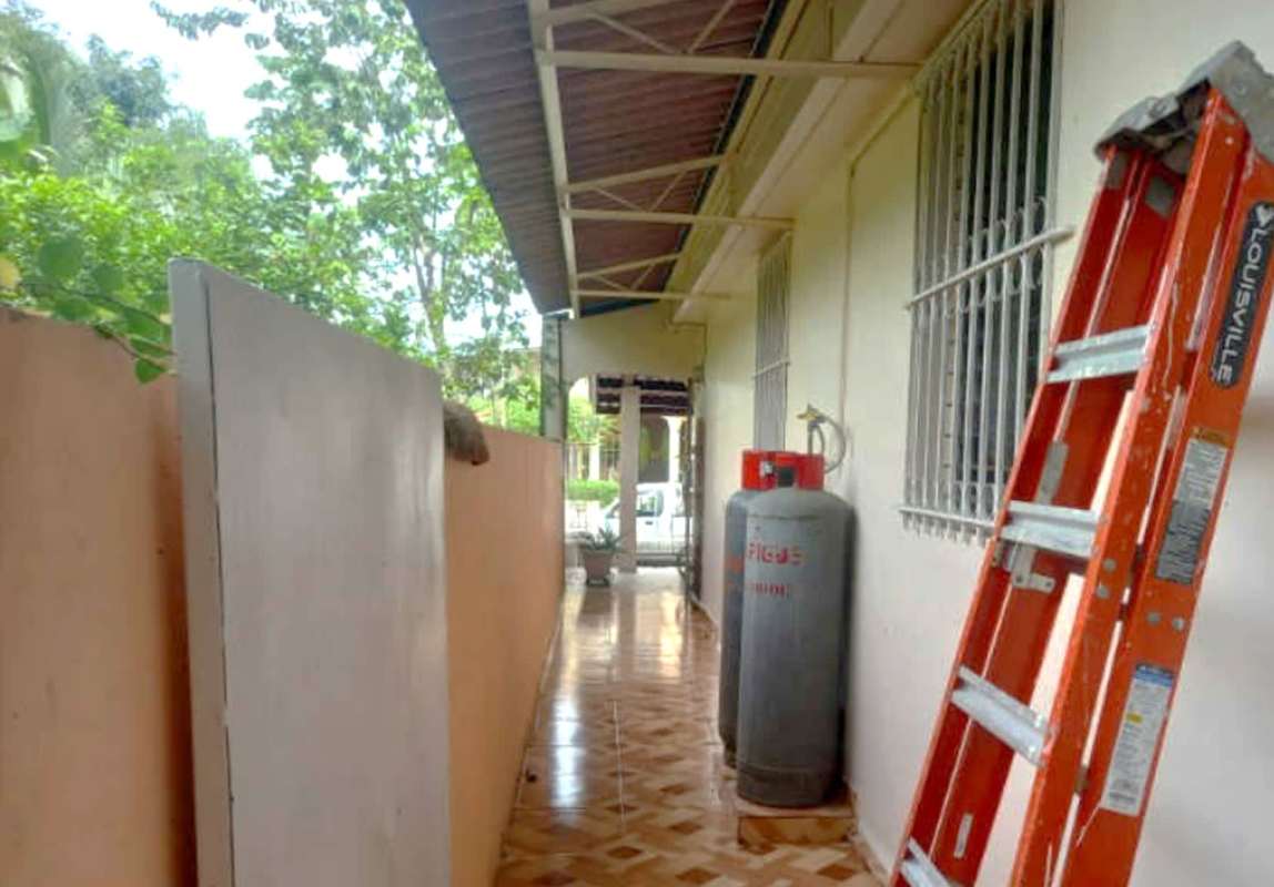 Covered outdoor service corridor with utilities and fencing PH Torres de Toscana Panama