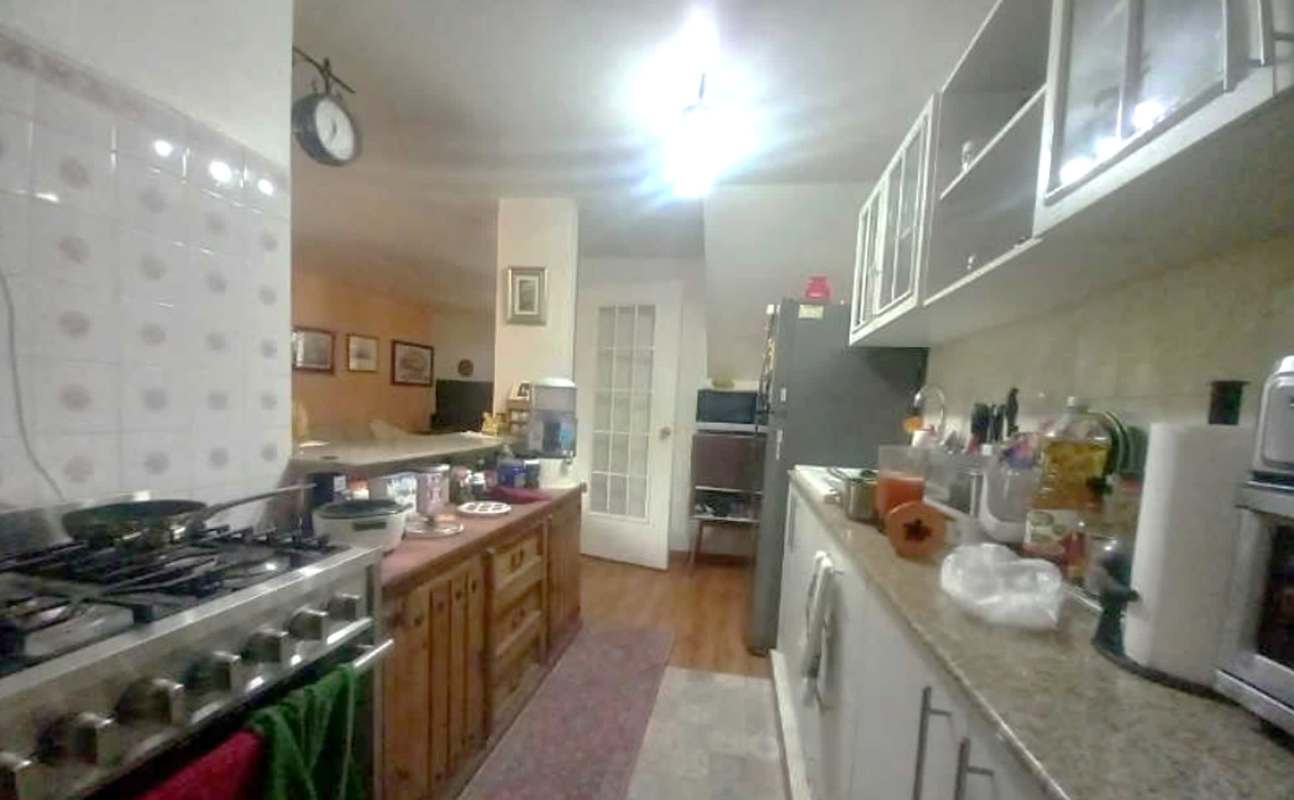 Remodeled kitchen with granite countertops, wooden cabinets, modern appliances PH Torres de Toscana Condado del Rey