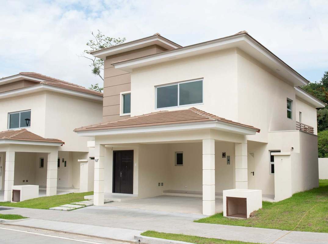 Modern bedroom with king bed, upholstered headboard, large window, cream tones in Altos del Parque