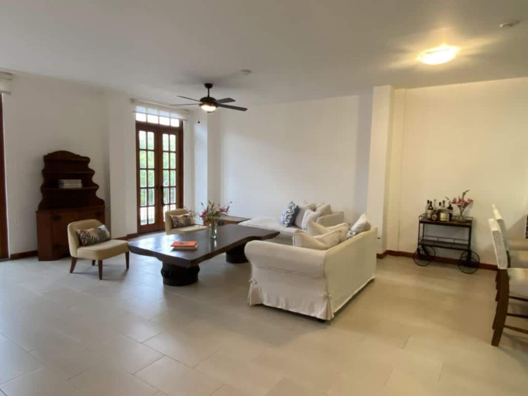 Contemporary kitchen with wood cabinets, island, stainless appliances, and blue tile backsplash