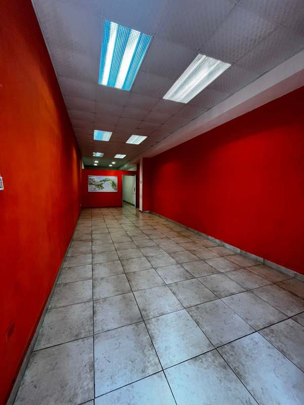 Commercial entrance with red accent walls and tiled floors PH Jardines Hotel Panama