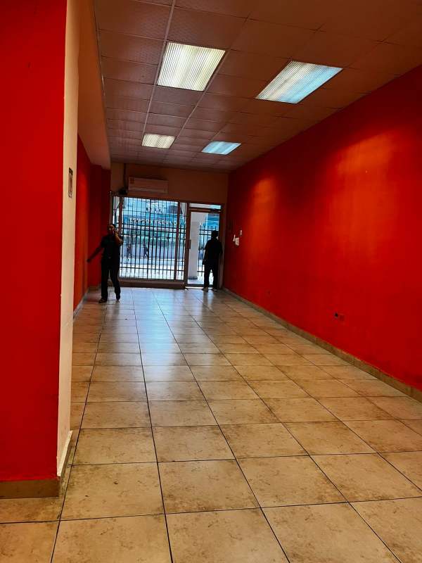 Commercial property interior with glass front, white tile floors, and security gate PH Jardines del Hotel Panama