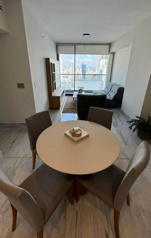 Modern living-dining area with panoramic windows ocean and city view Nuovo by Armani Casa Panama