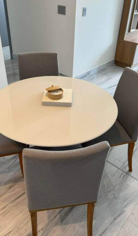 Dining area with modern decor round table and gray chairs Nuovo by Armani Panama
