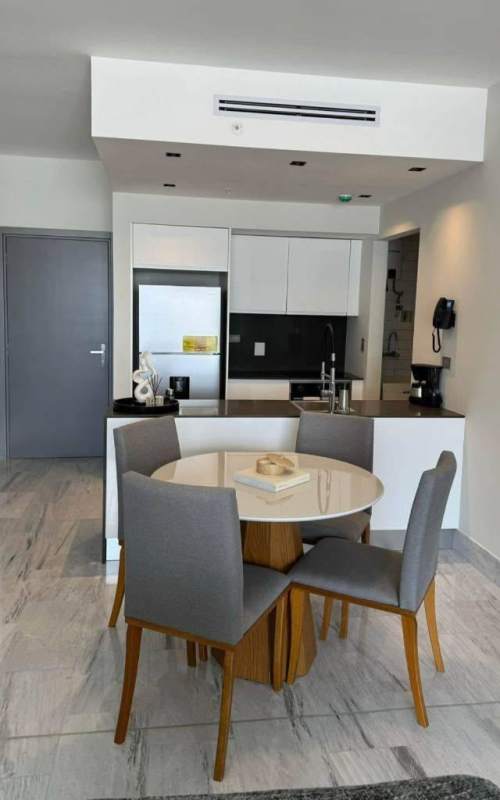 Open plan living and dining area with marble floor, modern design, skyline view Nuovo by Armani Casa Panama City