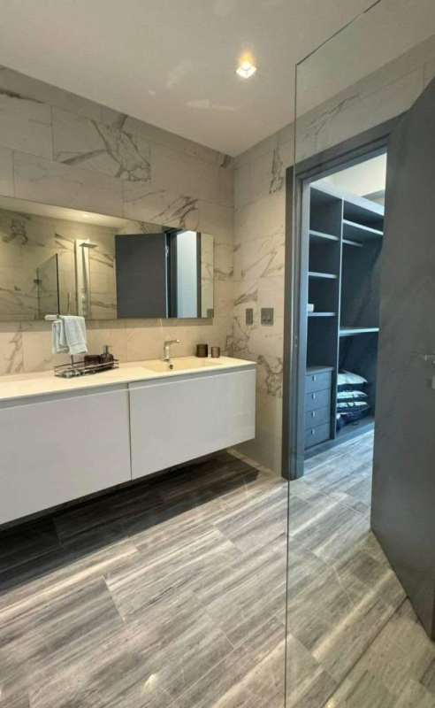 Contemporary bathroom with marble walls, floating vanity and walk-in closet Nuovo by Armani Casa Panama City