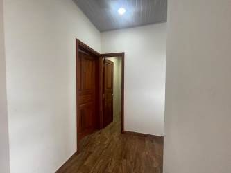 Modern country home hallway with wooden floors and doors in Las Lajas Panama