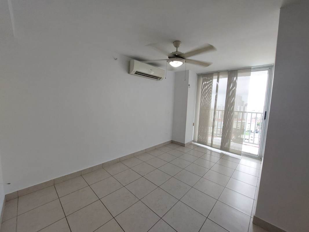 Living area with large window, balcony, tile floor, ceiling fan in PH Riverside Panama City
