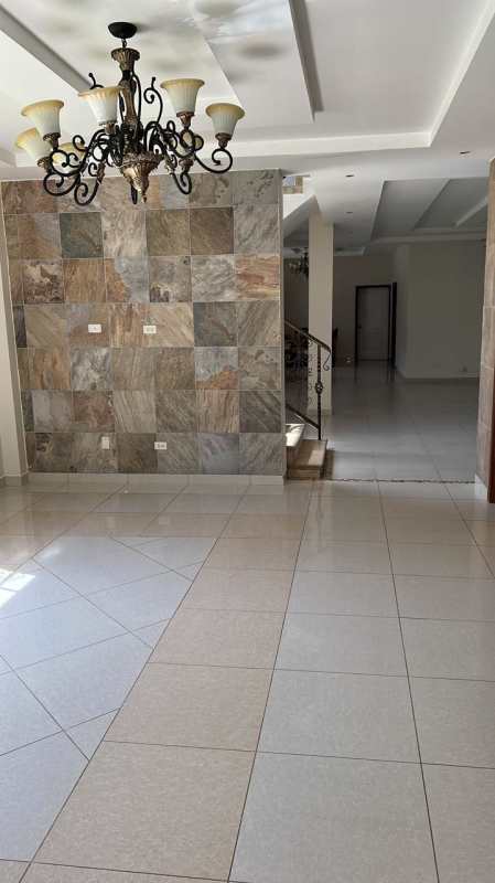 Luxury interior staircase with wrought iron rail, large windows and natural light, Clayton area house Panama