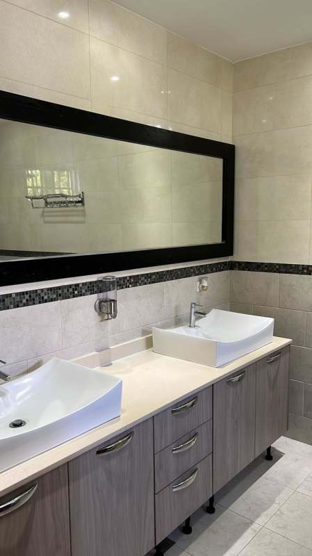 Spacious bathroom with corner tub, mosaic tile surround, walk-in shower Llanos de Curundu house Panama