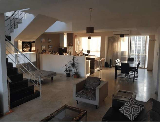 Spacious dining and living area with open concept, city ocean views, staircase, Sol Marina Panama