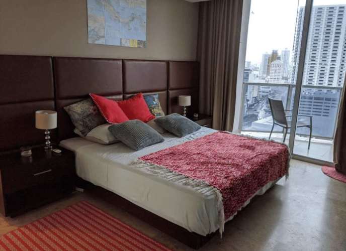 Modern living entertainment space with staircase and ocean-city view windows in Sol Marina Tower Panama City