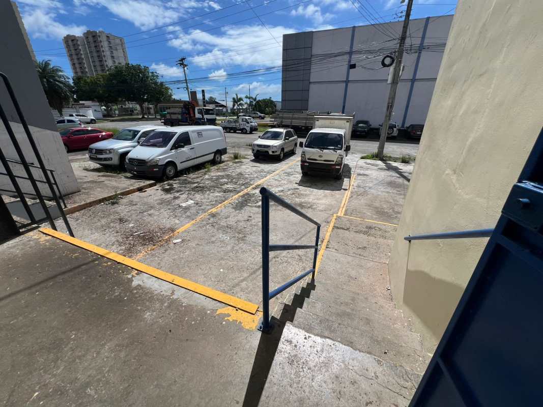 Spacious warehouse interior with high ceiling, blue steel beams, concrete floor, mezzanine access Los Pueblos Panama