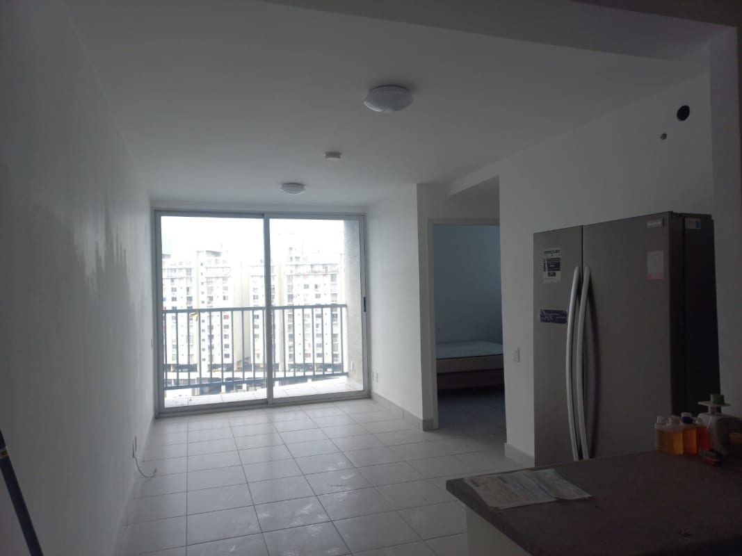 Living room with sliding door to balcony city skyline PH Ilo Río Abajo Panama apartment