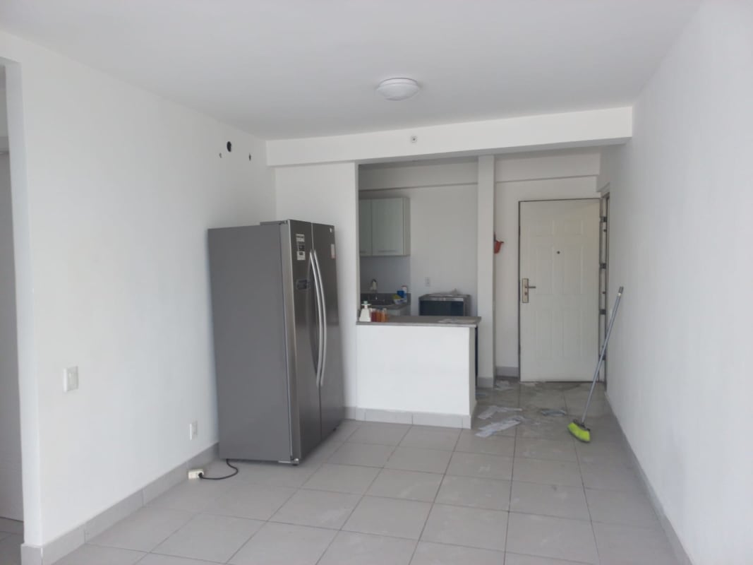 Living and dining area with large sliding glass door to balcony PH Ilo Río Abajo Panama City apartment