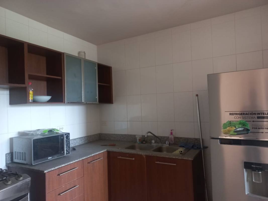 Kitchen with granite countertop, cabinets, refrigerator, microwave in Mallorca Park Village Los Andes Panama