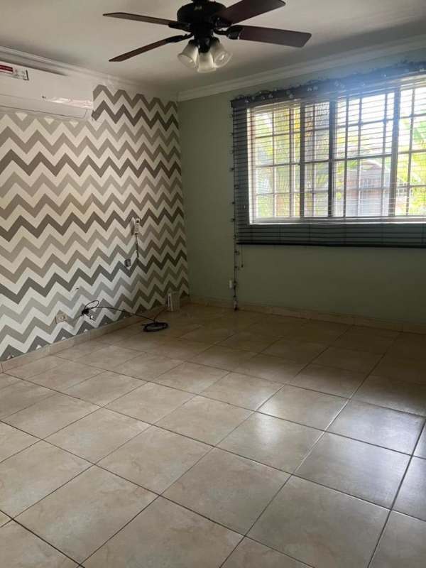 Traditional kitchen with wood cabinets, tile backsplash, large window in Residencial Bariloche Panama