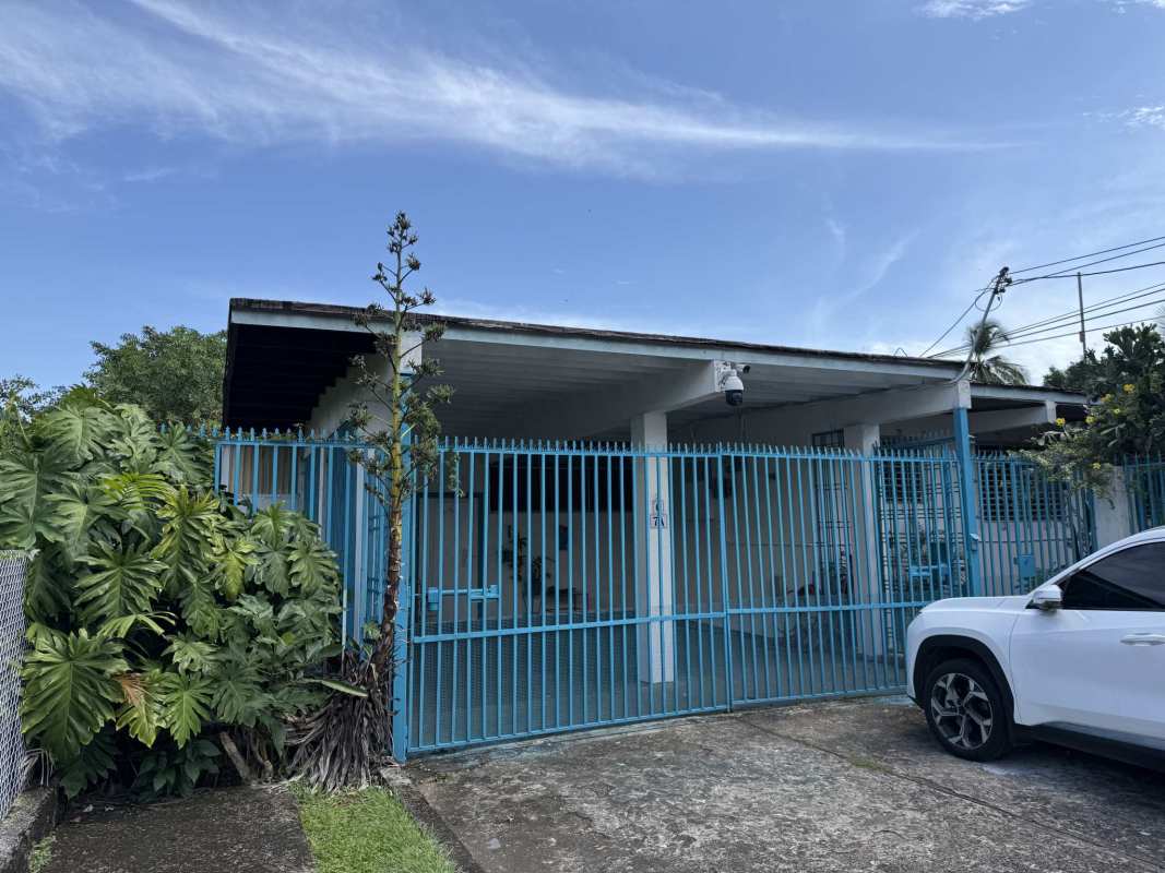 Blue gate lush vegetation driveway luxury oceanfront home Panama City Coco del Mar