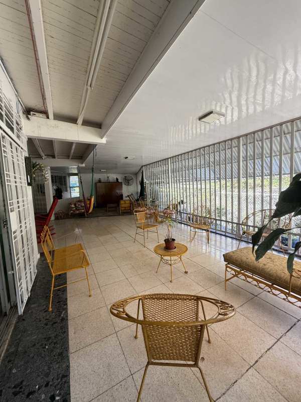 Interior enclosed patio with hammock wicker furniture tropical garden view Panama house