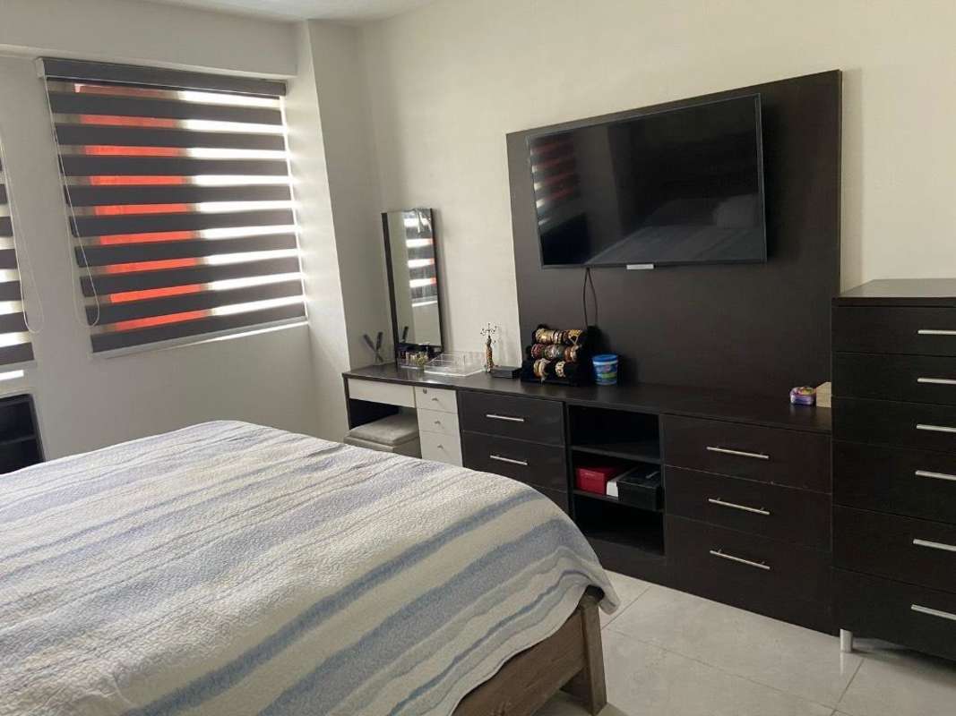 Modern master bedroom with wardrobe and flat-screen TV PH San Francisco Condo