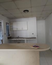 Basic kitchen with breakfast bar, upper cabinets, and ceramic tiled floor El Palmar Chapala rental house Arraijan Panama