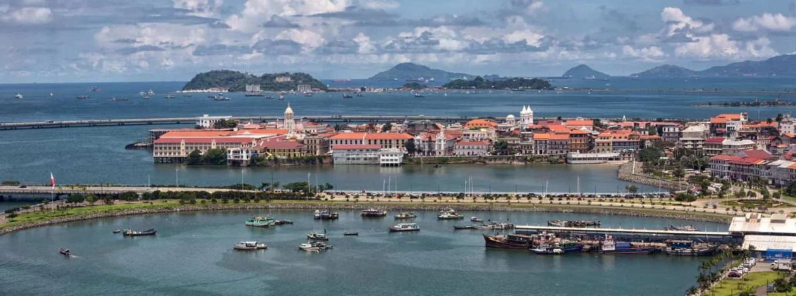 Aerial of Casco Viejo waterfront colonial buildings ocean islands in the distance Panama City