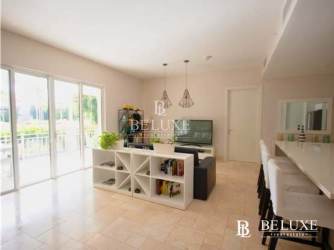 Bright modern kitchen with island and appliances in Puntarena Ocean Village Panama