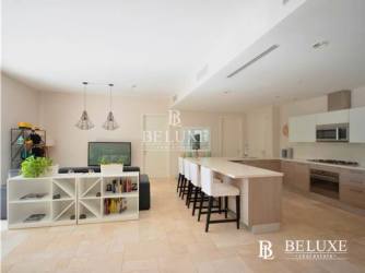 Living room with floor to ceiling glass and terrace overlooking pool Buenaventura