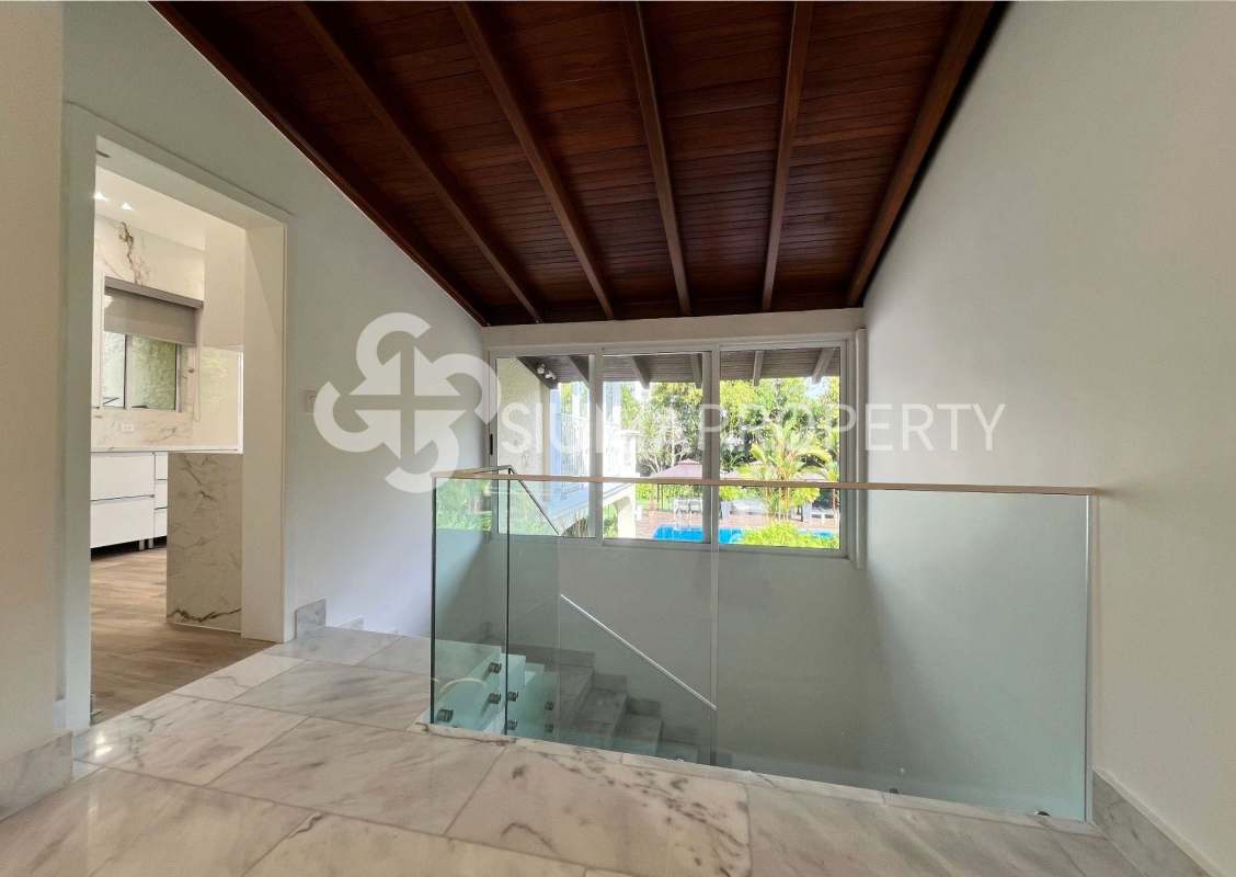 Spacious modern bedroom with marble flooring and large windows in Panama City villa