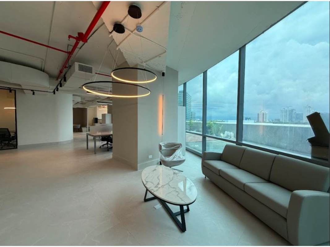 Modern workspace with tiered wooden benches, pendant lights, exposed ceiling in Financial Park Panama