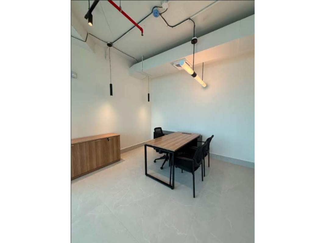 Modern office lounge with gray sofa, marble coffee table, panoramic city view at Financial Park Tower Panama