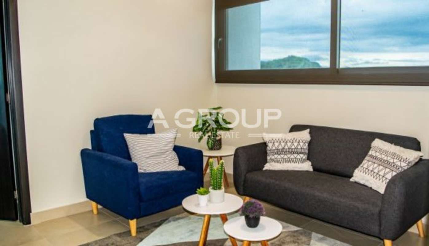 Modern minimalist living area with large windows at PH Country Heights Condado del Rey