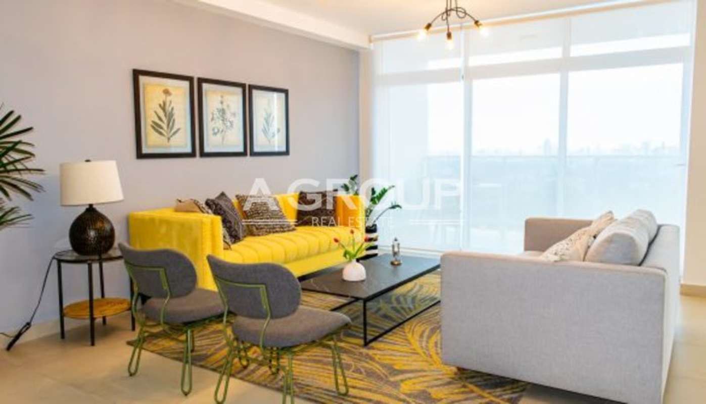 Bright living room with large windows and yellow sofa at PH Country Heights Condado del Rey