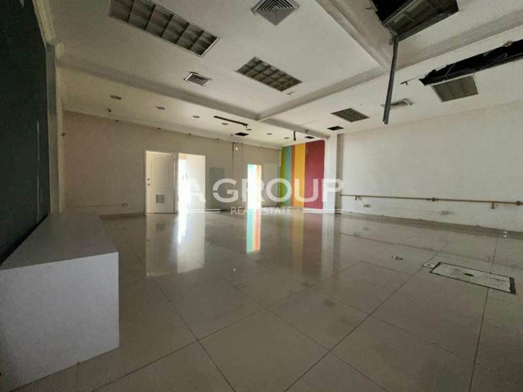 Commercial unit interior showing tiled floors, colorful striped wall, reception counter at PH Galería Cincuentenario Juan Díaz Panama City