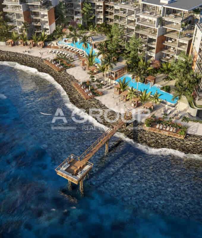 Aerial shot of luxury oceanfront towers, swimming pools, tropical landscaping and pier at Ocean Reef Islands