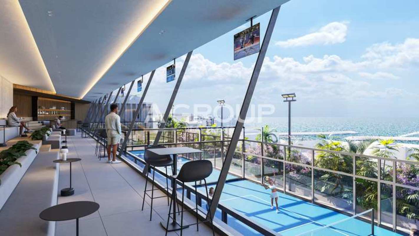 Modern indoor lounge space with glass wall viewing sports court and ocean at Ocean Reef Islands Panama