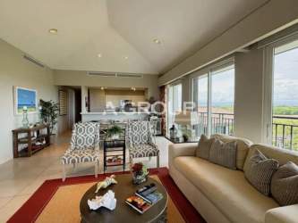 Spacious living dining room with large windows, balcony access in Laguna Buenaventura condo