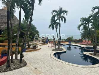 Tropical palapa covered patio area perfect for dining and lounging at Punta Roca beach villa Panama