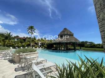 Large swimming pool with tiki hut bar surrounded by palm trees Buenaventura beach resort Panama