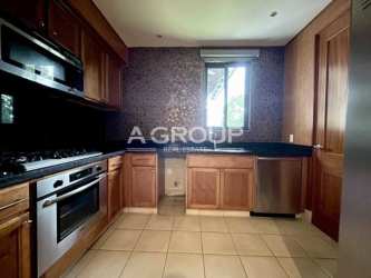 Kitchen with built-in appliances and wood cabinetry Buenaventura beach condo Panama