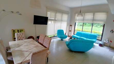 Bright open plan living and dining area in PH Nativa Panama Pacifico with large windows and modern design