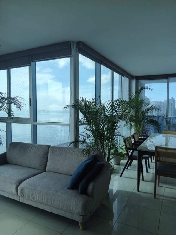 Bright living room floor-to-ceiling windows with ocean view PH Waterfalls