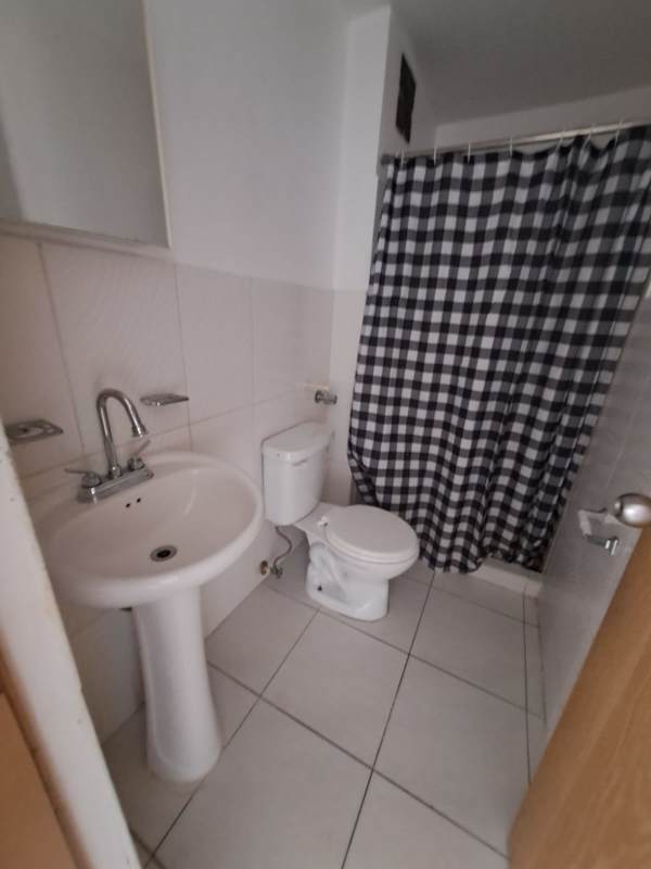 Empty bedroom with window, white walls and tiled floor apartment Panama City