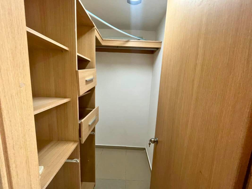 Walk-in closet wooden shelves drawers tile flooring PH Via Porras Panama