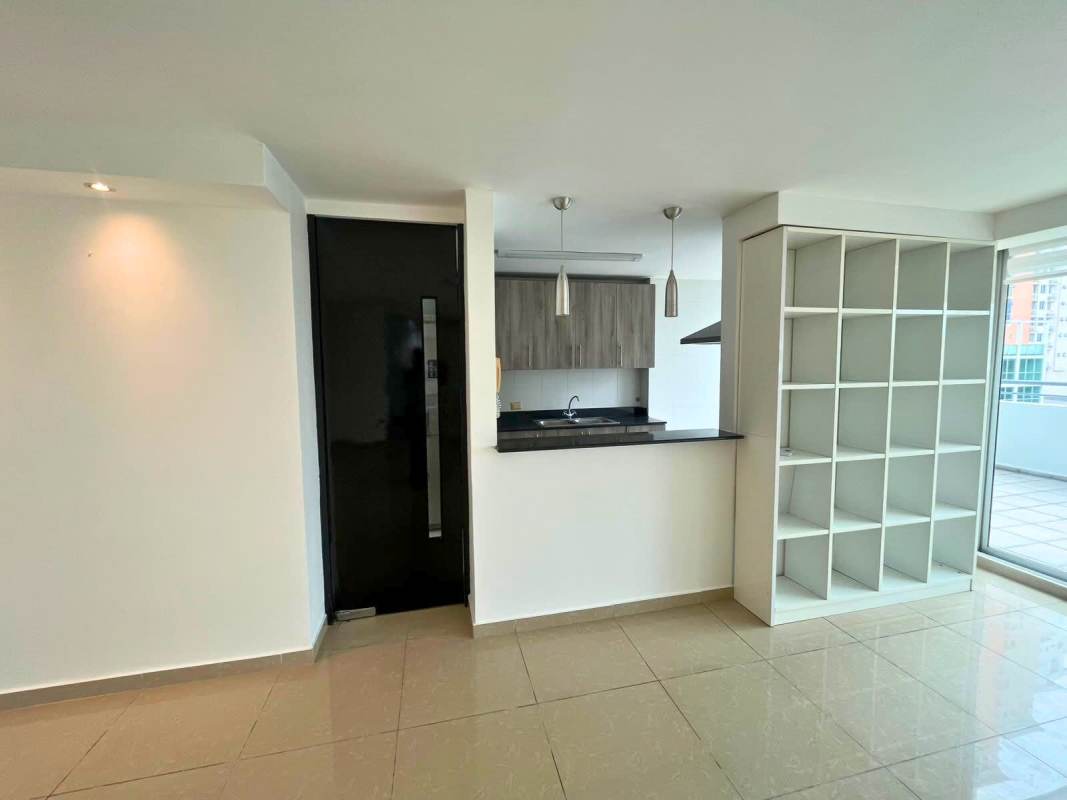 Open kitchen with shelves black counters pendant lights PH Via Porras Panama